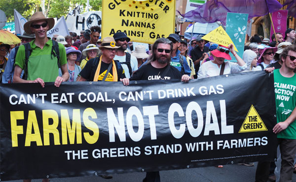 Pakistani and Filipino farmers protesting against fossil fuel polluters, demanding climate justice and compensation for crop losses caused by floods and storms