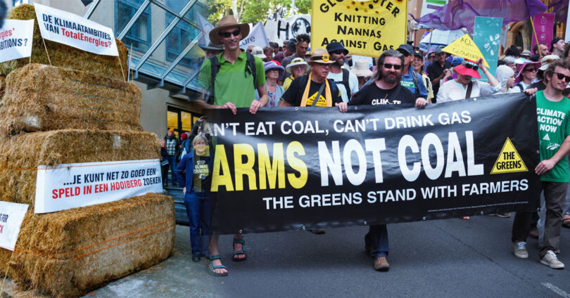 Pakistani and Filipino farmers protesting against fossil fuel polluters, demanding climate justice and compensation for crop losses caused by floods and storms