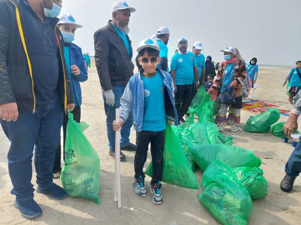 Children of Generation Alpha cleaning the beach with gloves and tongs at Karachi Sea View, promoting environmental awareness