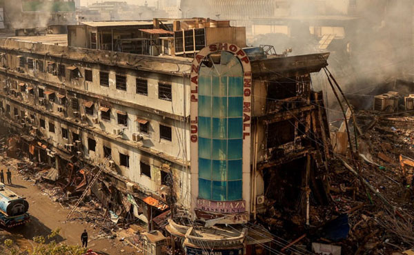 Gul Plaza Karachi fire aftermath showing burnt commercial building and rescue operations