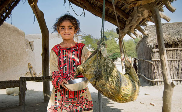 Women and children carrying water containers across rocky mountain paths in Kunraj, Balochistan due to clean water shortage