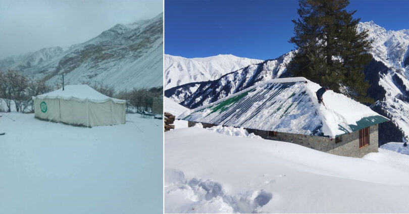 Snow-covered tents and a house buried under heavy snowfall in a mountainous region of Gilgit-Baltistan, highlighting extreme winter weather conditions.