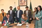 Officials from Pakistan and Norway sign a bilateral climate agreement under Article 6.2 of the Paris Agreement during a formal ceremony in Islamabad, with representatives standing behind and national flags displayed.
